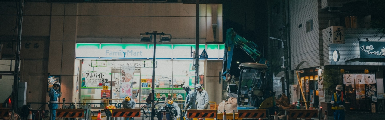 workers on a street at night